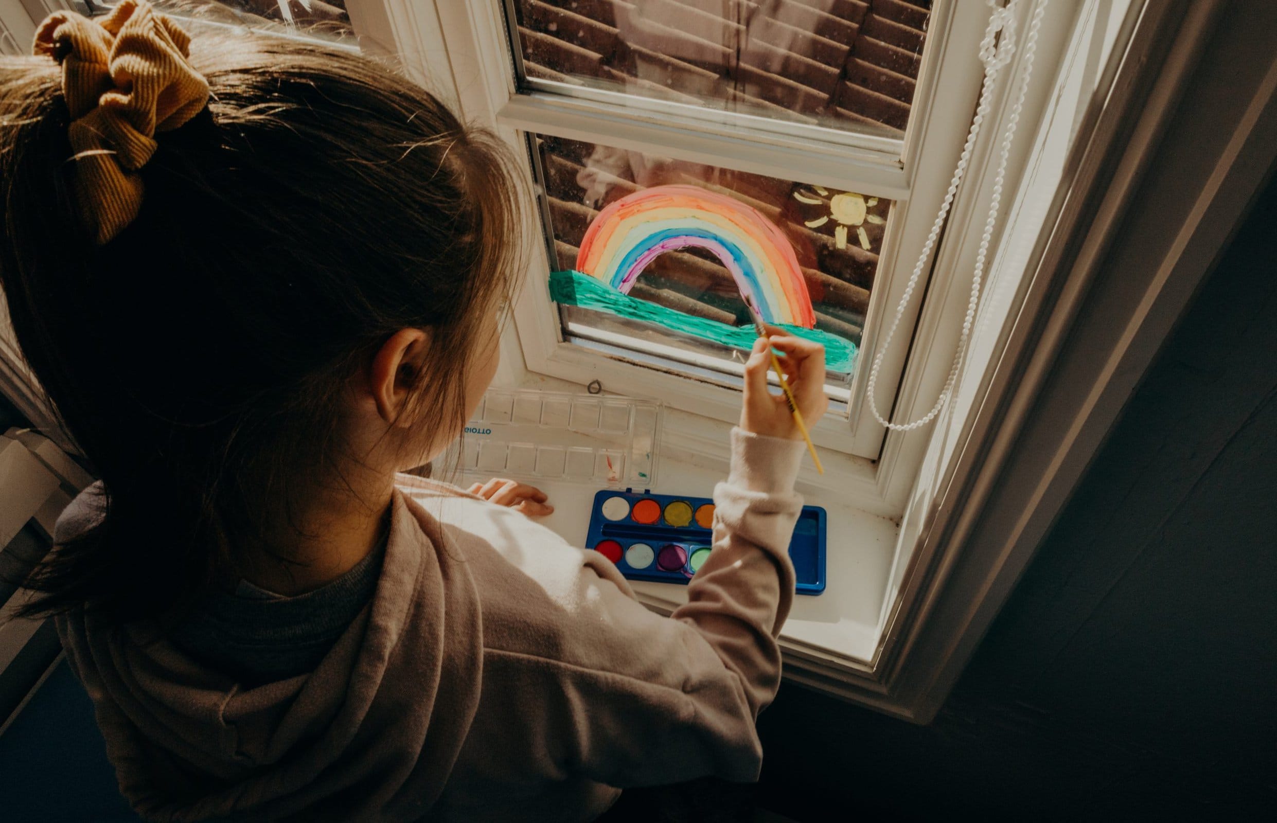  child painting on window scaled