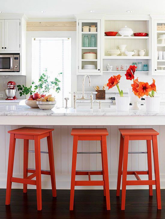 white kitchen adn strong orange accents