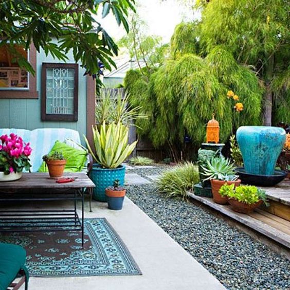 The jungle bookDesigner Di Zock let a ceramic fountain (far right) serve as the inspiration for her outdoor room. She had no idea how she was going to use the ceramic elephants (to left of fountain) when she saw them at a thrift shop. “But I knew they were just the right touch of whimsy.” Between discarded pots and “wainscoting” a terra-cotta pot in blue, Di coughed up only $10. The turquoise-and-brown rug, made from recycled plastics, dresses up the gardenMore: See the rest of this chic aff...