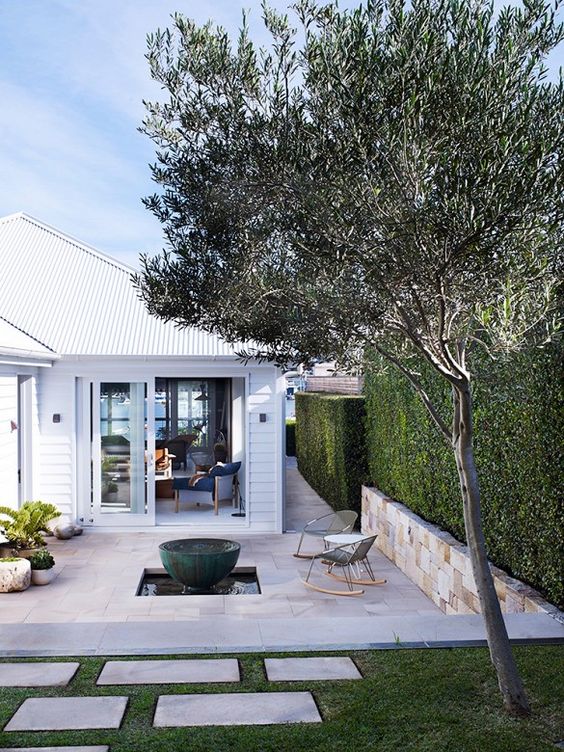 Outdoor space with fire pit and surrounding rocking chairs.